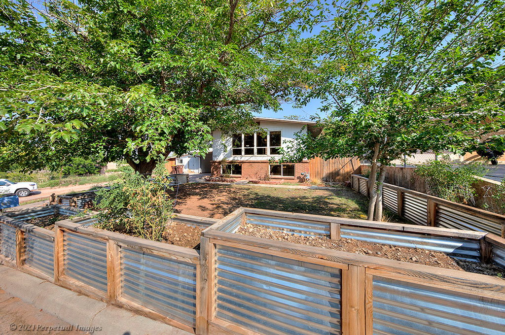 View of front of property featuring raised garden beds.