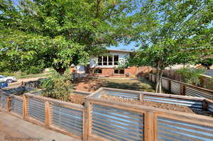 View of front of property featuring raised garden beds.