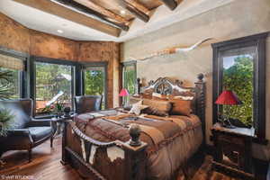 Bedroom featuring dark wood-style flooring, beam ceiling, and recessed lighting
