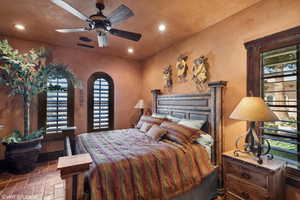 Bedroom with stone tile floors, ceiling fan, and recessed lighting