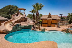 View of pool with a patio area and area for grilling