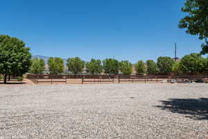 View of yard featuring an enclosed riding area and a view of rural / pastoral area