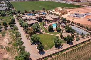 Overview of rural landscape with a pool area and large plots for crops