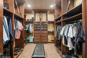Spacious closet featuring light carpet