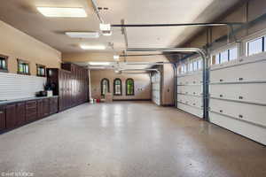 Garage with a garage door opener and baseboards