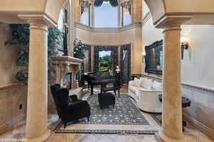 Common area featuring a wainscoted wall, a high ceiling, and tile walls
