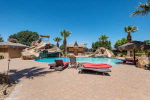 View of swimming pool featuring a water slide and a patio area