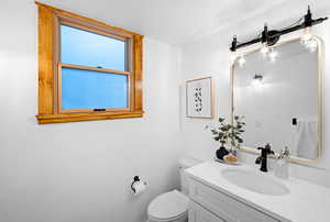 Bathroom featuring vanity and toilet