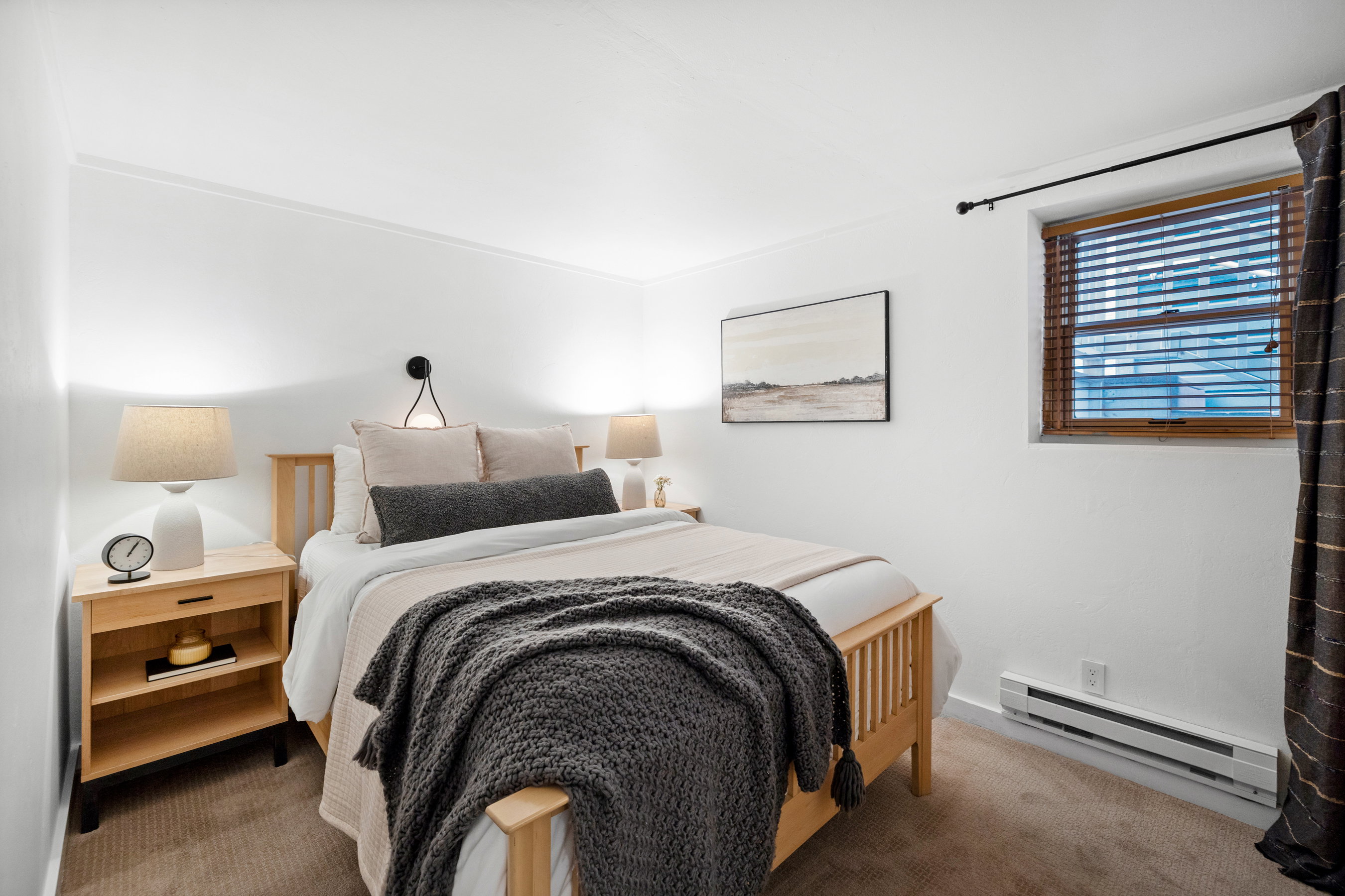 Bedroom with baseboard heating and carpet