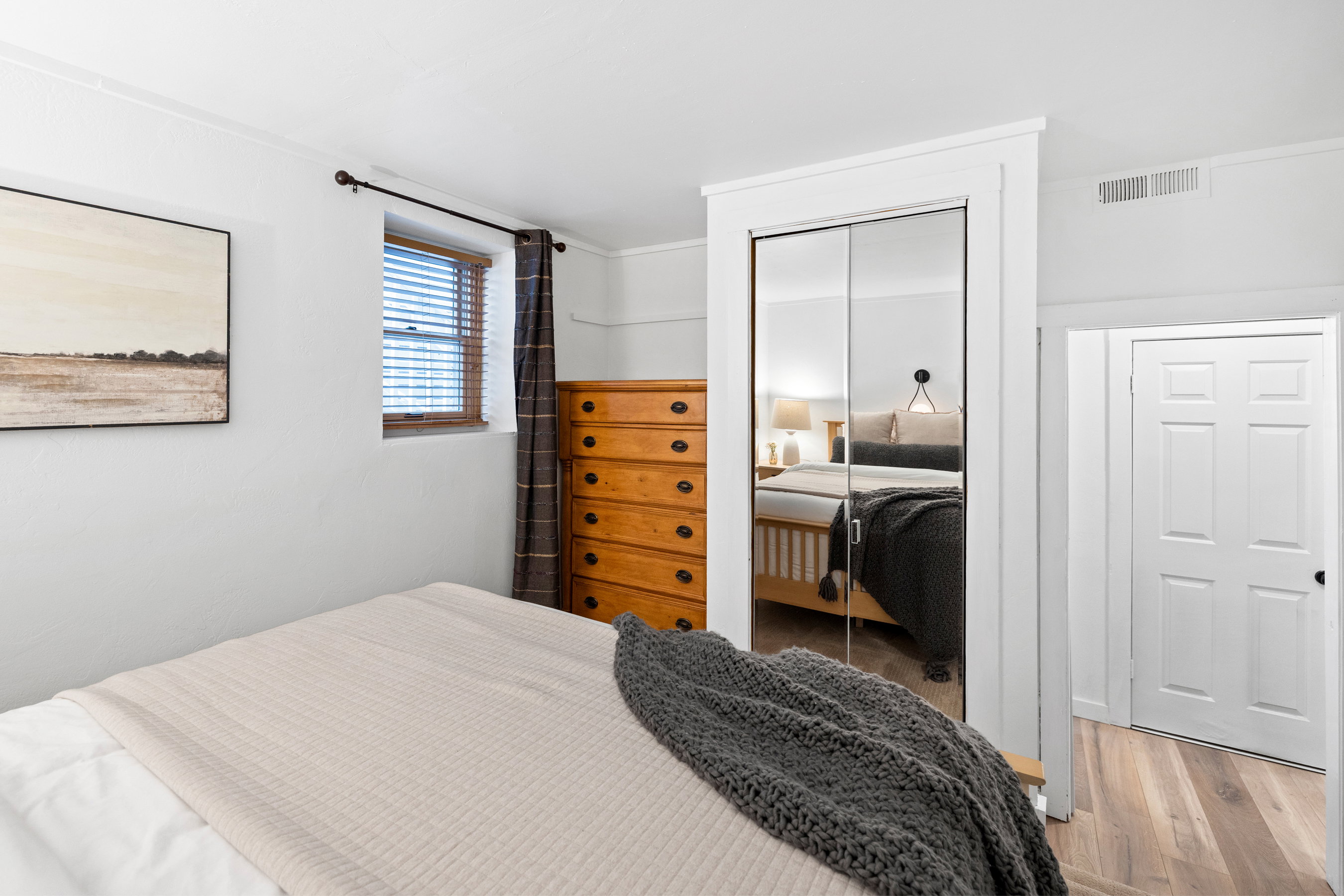 Bedroom featuring wood finished floors and a closet
