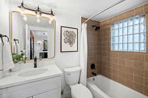 Full bathroom featuring shower / bath combination with curtain and vanity