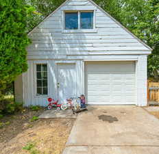 Detached garage featuring concrete driveway
