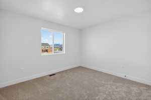 Empty room featuring carpet floors and baseboards
