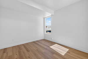 Bonus room featuring light wood-style flooring and baseboards