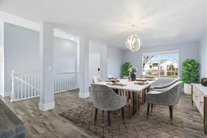 Dining area featuring suspended lighting and light wood-style flooring