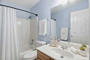 Full bathroom featuring shower / tub combo with curtain and vanity