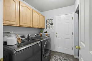 Laundry area with cabinet space and washing machine and dryer