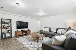 Living room featuring light wood-style floors and baseboards