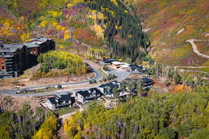 Aerial view of property and surrounding area with a heavily wooded area