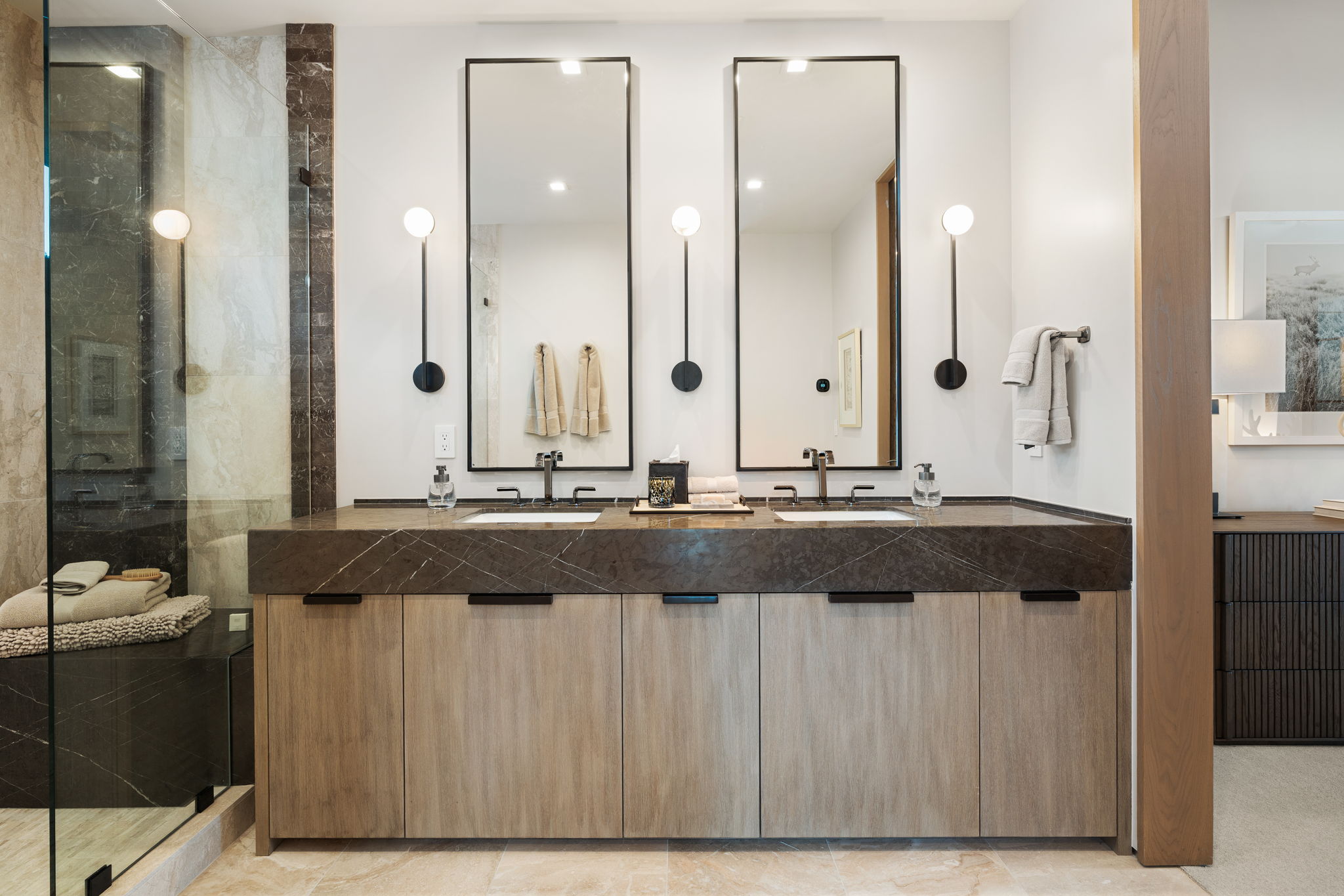 Full bathroom featuring double vanity and a walk in shower