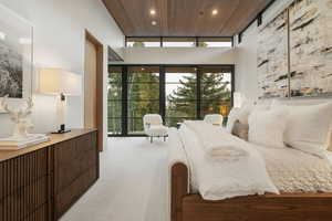 Carpeted bedroom featuring a high wooden ceiling, recessed lighting, and access to outside