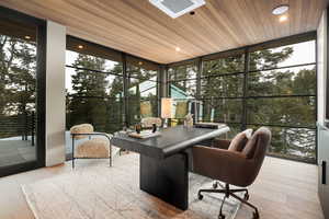 Office area featuring expansive windows, wood ceiling, light wood finished floors, healthy amount of natural light, and recessed lighting