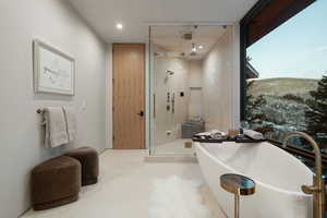 Bathroom featuring a freestanding tub, a stall shower, and recessed lighting