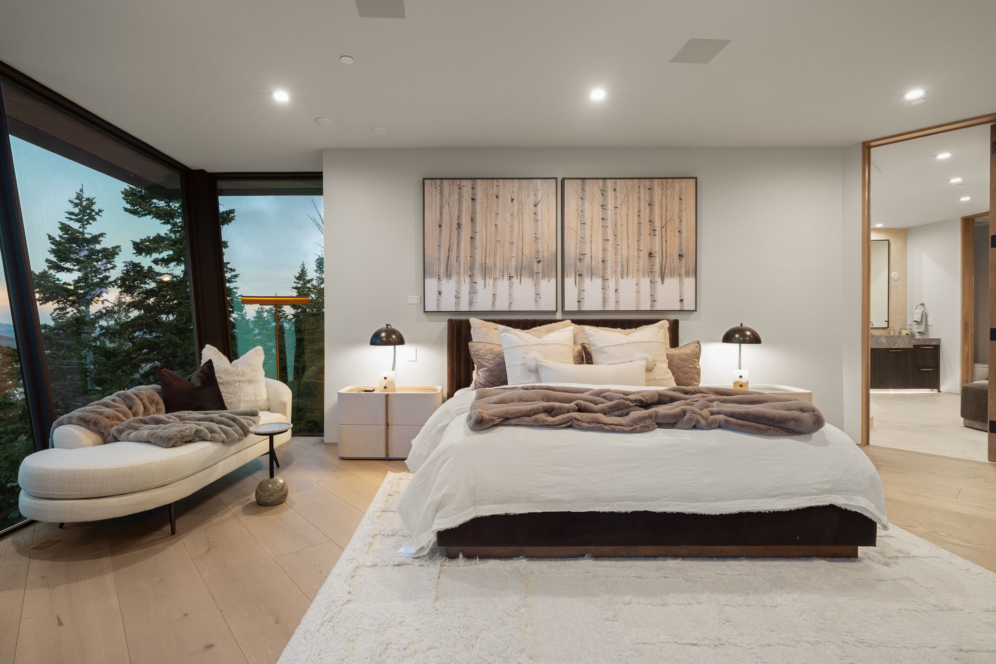 Bedroom featuring light wood-type flooring, floor to ceiling windows, and recessed lighting