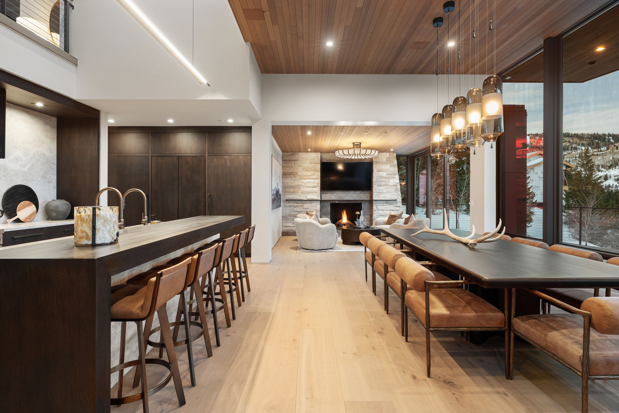 Dining space featuring wooden ceiling, a fireplace, light wood-style floors, and a chandelier