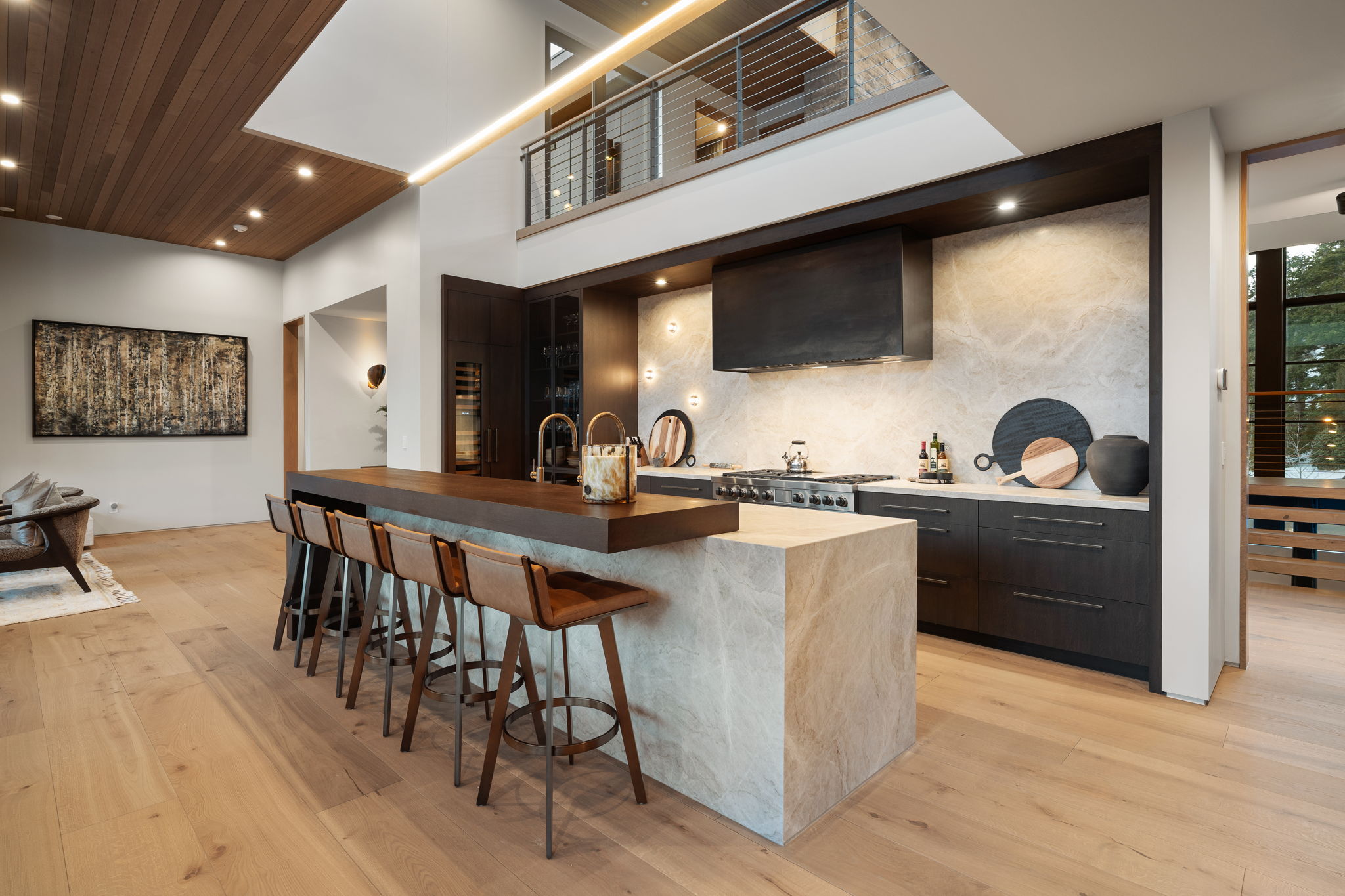 Kitchen with a kitchen bar, light wood-style flooring, a spacious island, wood counters, and modern cabinets
