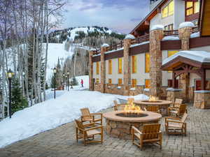Snow covered patio featuring a patio and a mountain view