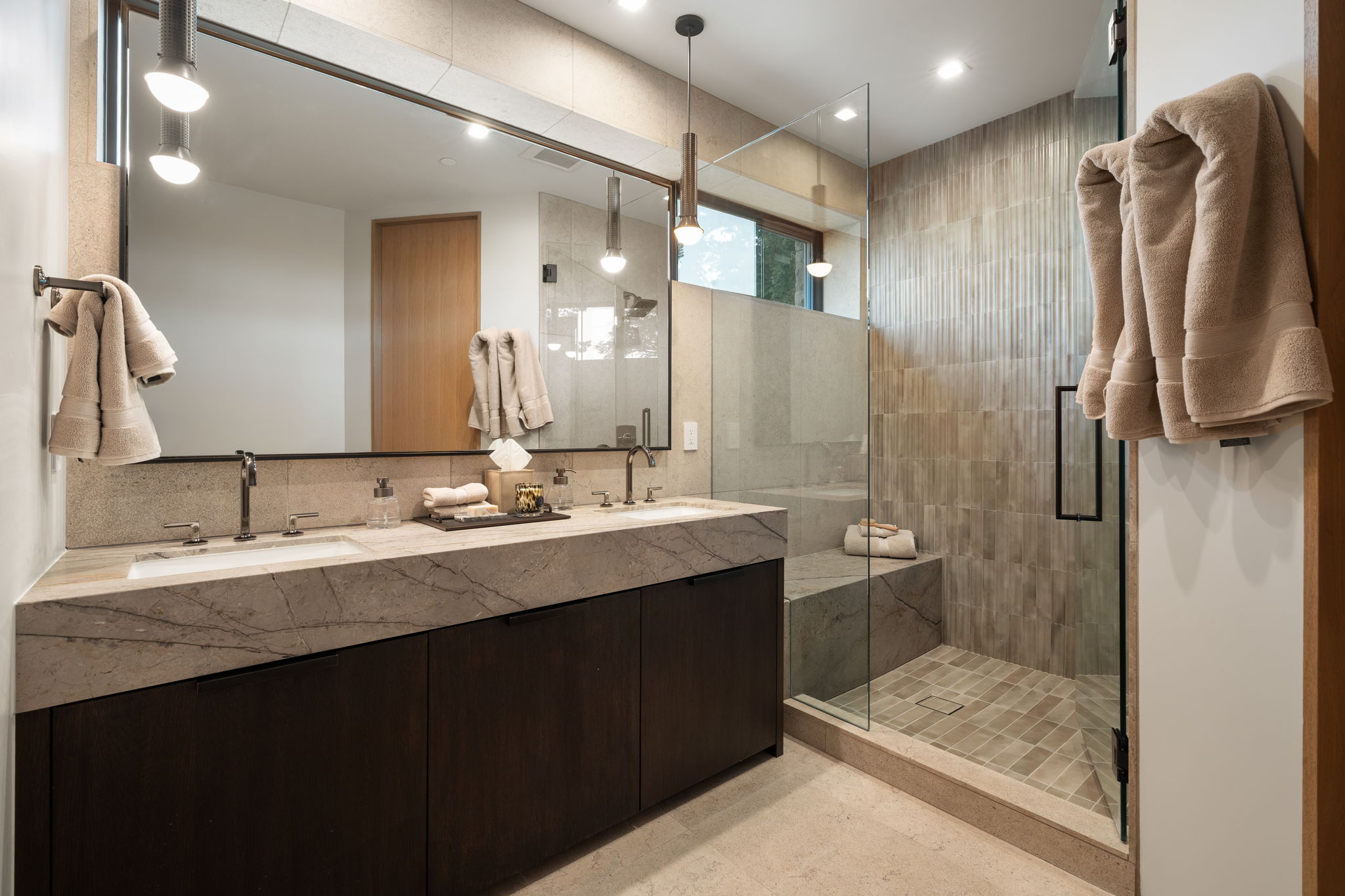 Bathroom with double vanity, a shower stall, and recessed lighting