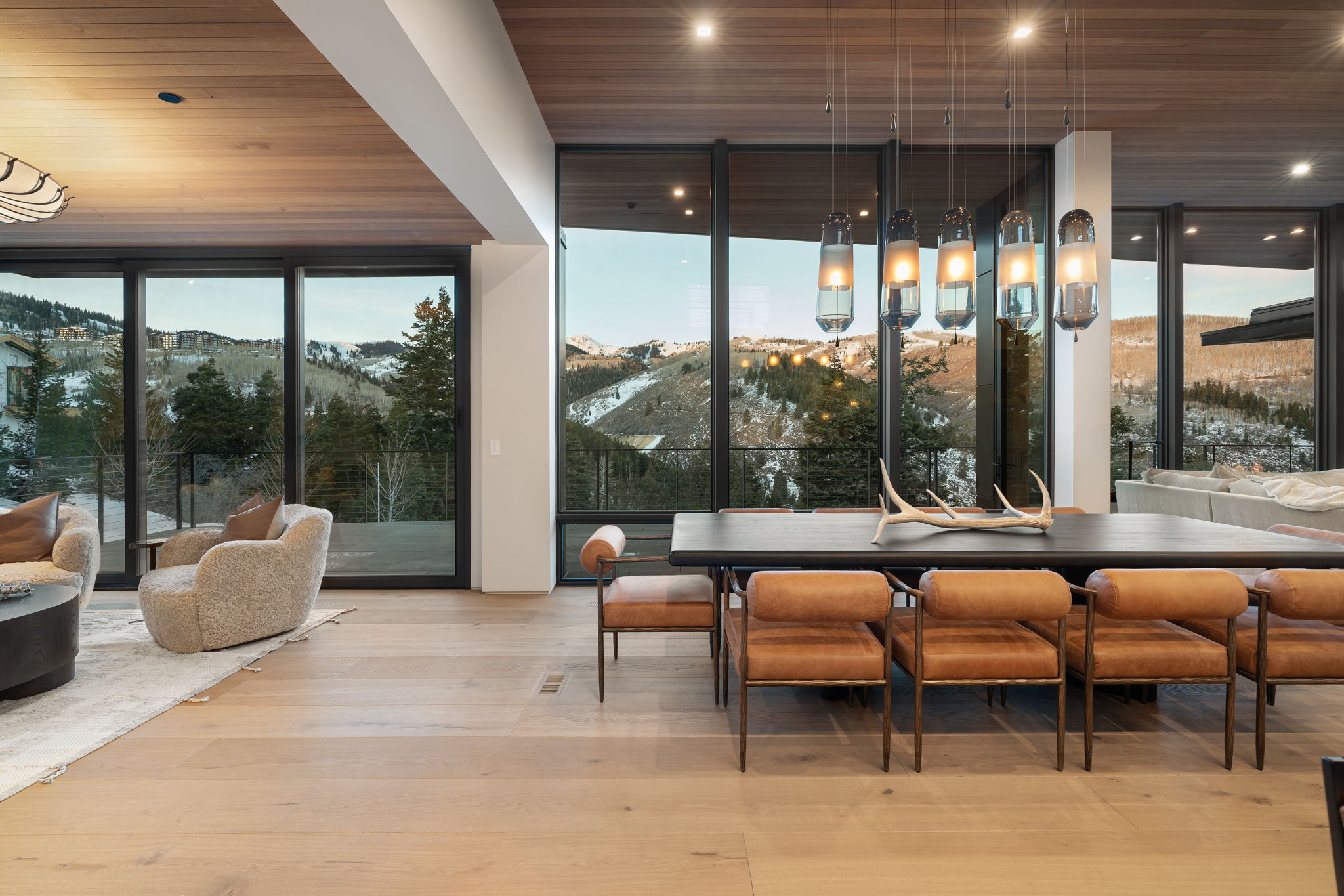 Dining area featuring wood ceiling, light wood finished floors, and floor to ceiling windows