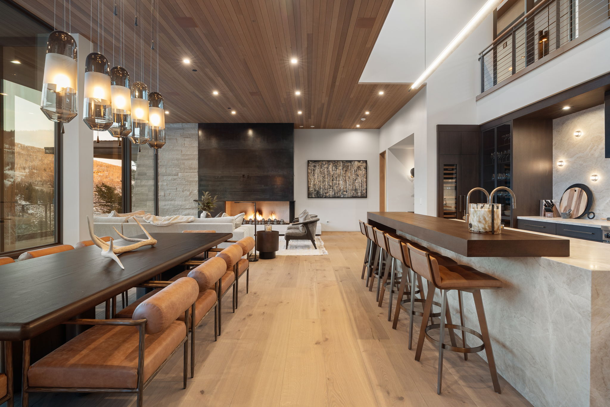 Dining room featuring light wood-type flooring, a large fireplace, recessed lighting, and wood ceiling