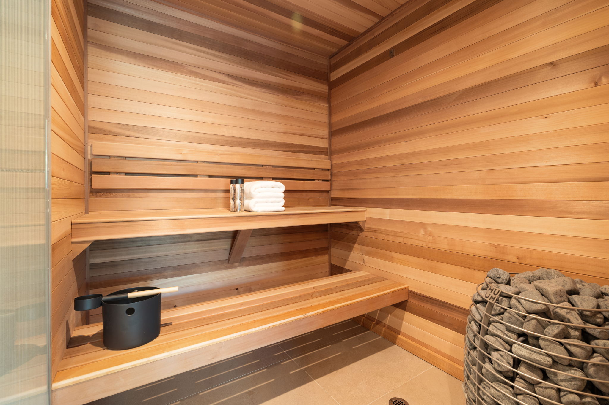 Relaxing sauna / steam room with wood walls, wood ceiling, and tile patterned floors