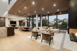 Community lobby with wood ceiling, a mountain view, expansive windows, and recessed lighting