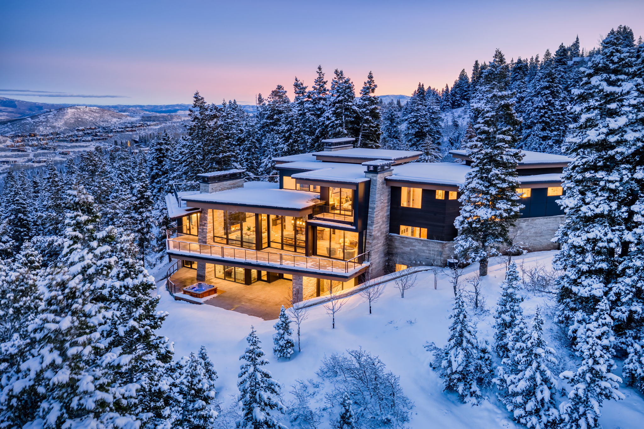 Snow covered house with a balcony and a chimney