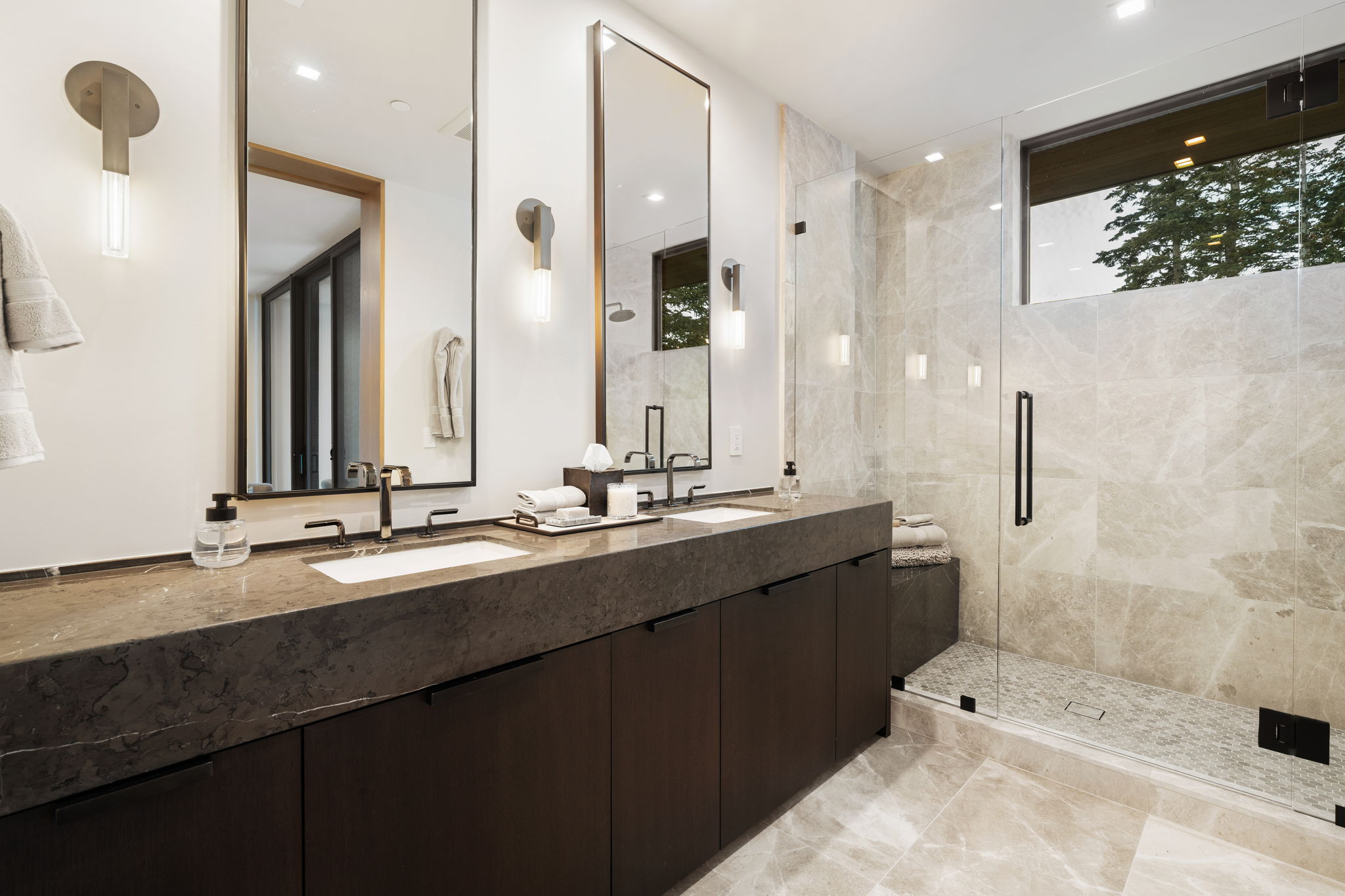 Bathroom with double vanity, a shower stall, and recessed lighting