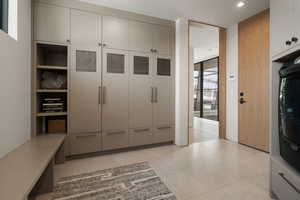 Mudroom featuring washer / clothes dryer and light flooring