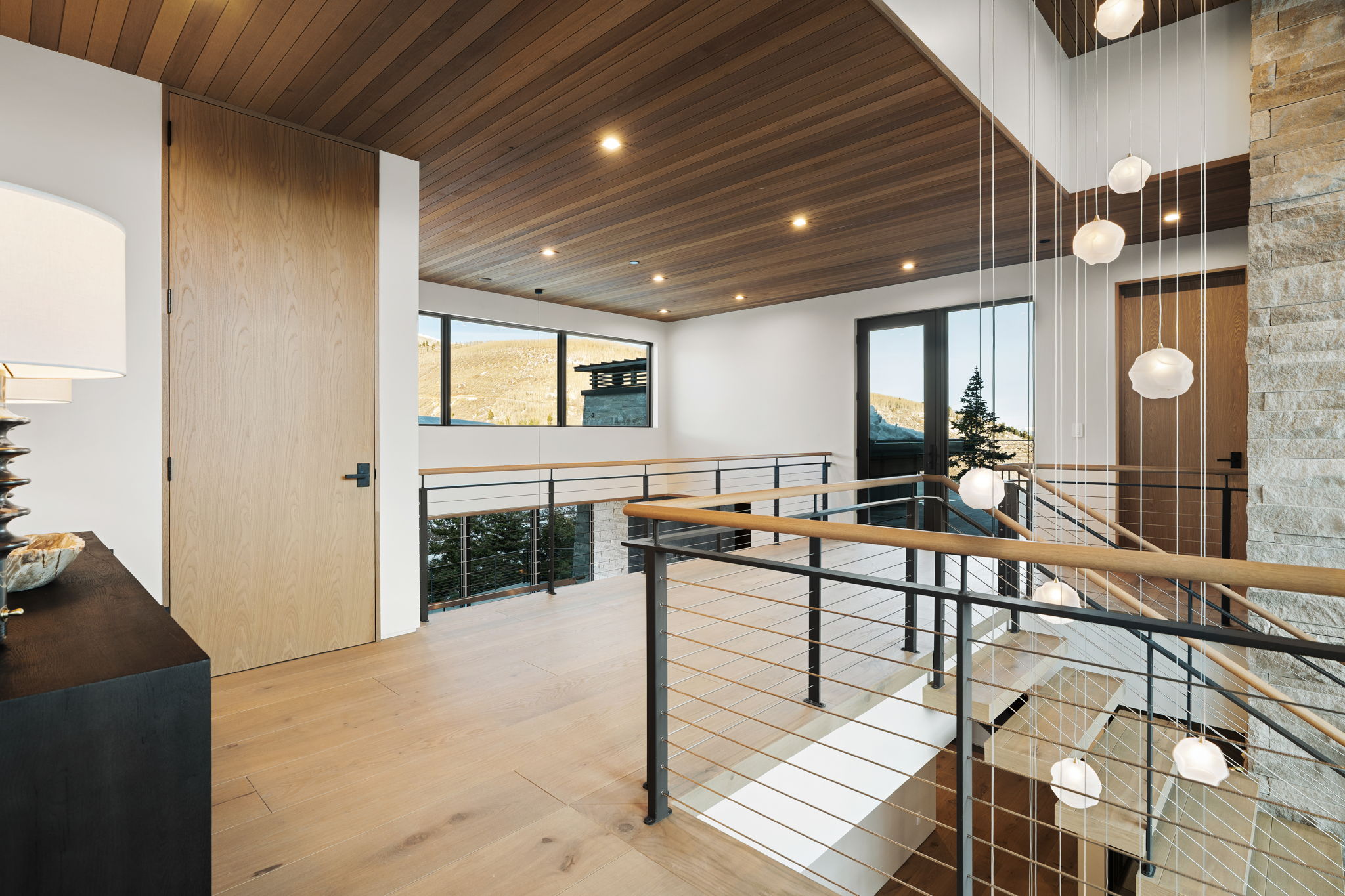 Hall with wooden ceiling, recessed lighting, light wood finished floors, plenty of natural light, and an upstairs landing
