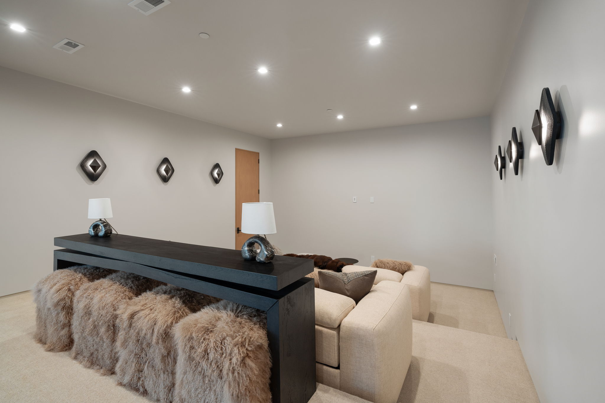 Living area with recessed lighting and light colored carpet