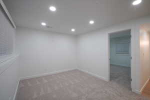 Unfurnished room featuring light carpet and recessed lighting