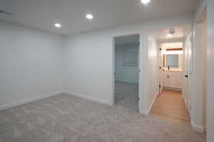 Corridor featuring light carpet and recessed lighting
