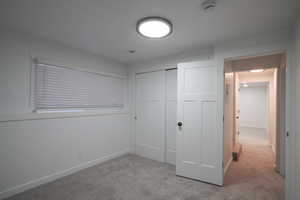 Unfurnished bedroom with carpet floors and a closet