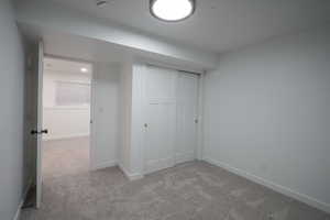 Unfurnished bedroom with carpet and a closet