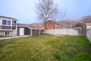 Fenced backyard featuring a patio and a mountain view