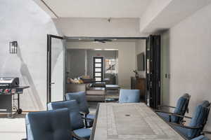 Office with a ceiling fan and a textured wall