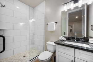 Full bath featuring vanity and a shower stall