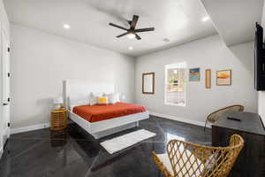 Bedroom featuring concrete flooring, ceiling fan, and recessed lighting