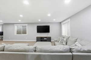 Living area with healthy amount of natural light, carpet, and recessed lighting